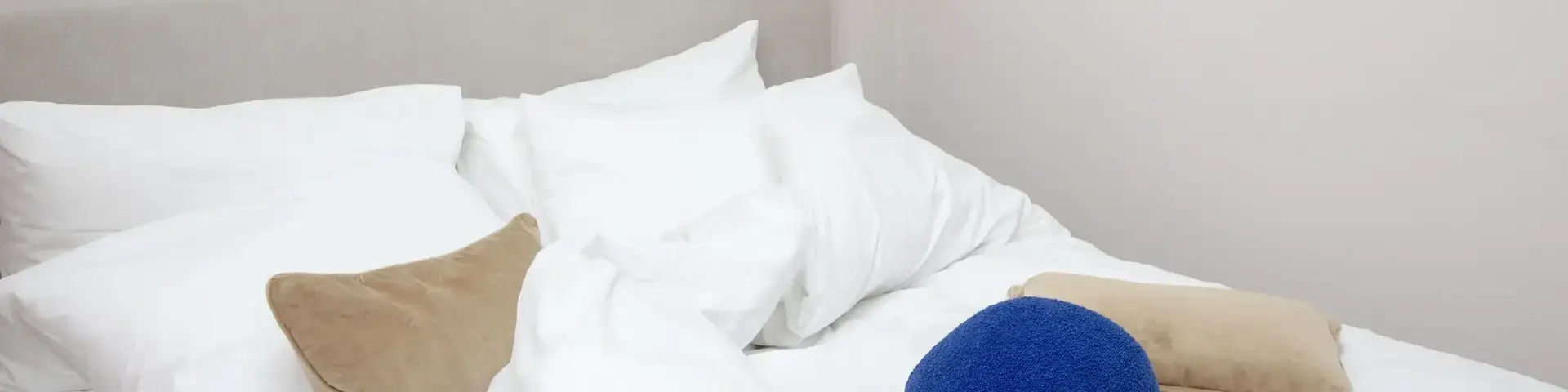 a blue ball on a bed