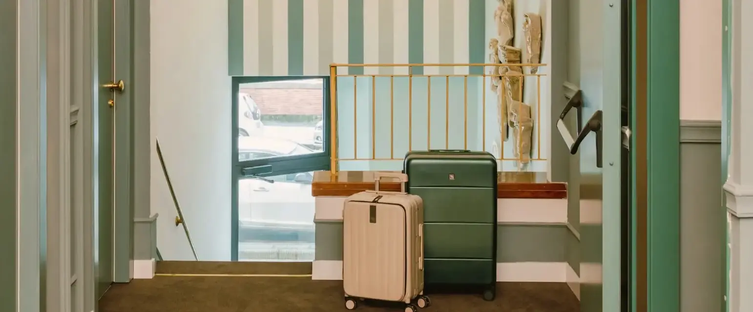 a hallway with a luggage and a chandelier