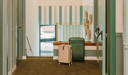 a hallway with a luggage and a chandelier