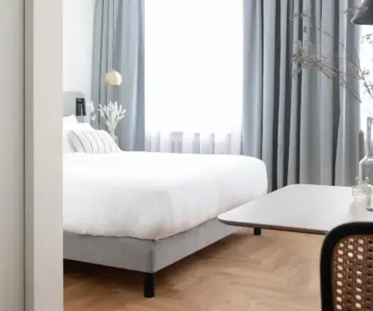 a bedroom with a bed and a table