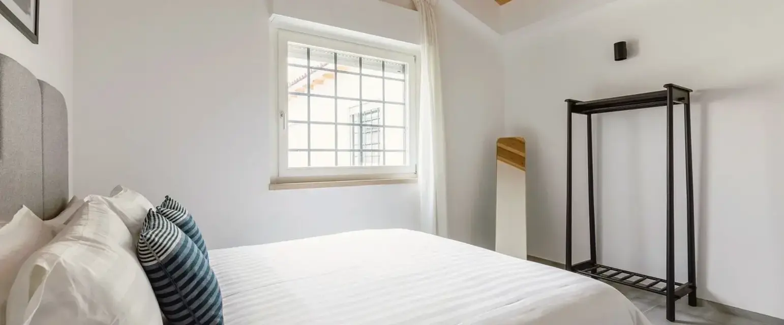 a bedroom with a bed and a window