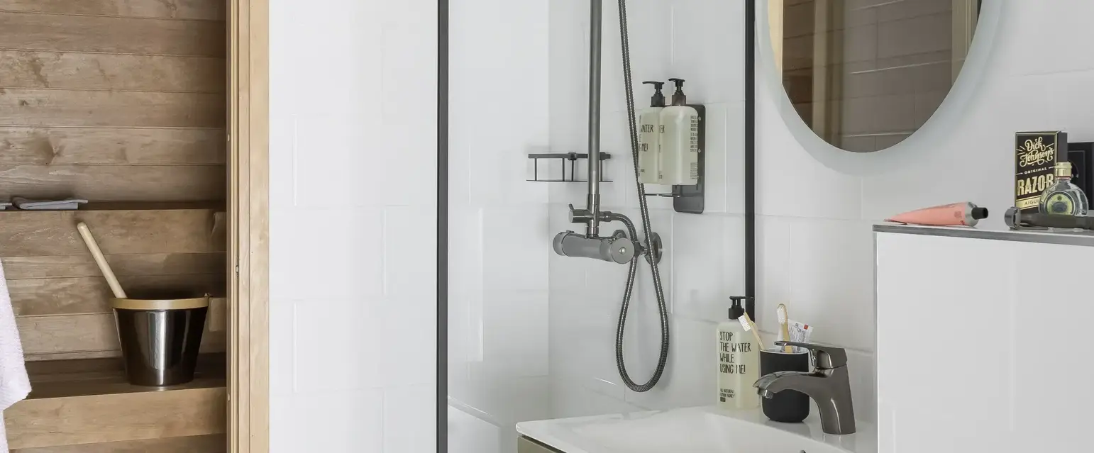 a bathroom with a shower and sink