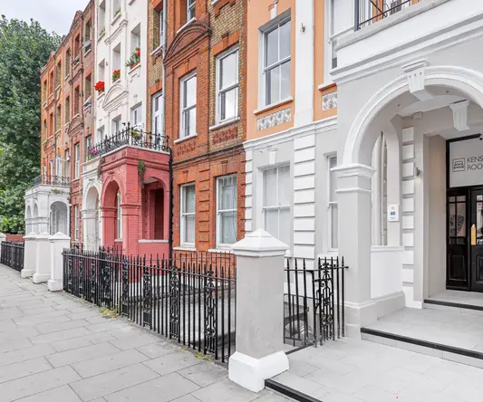 a row of buildings with a fence