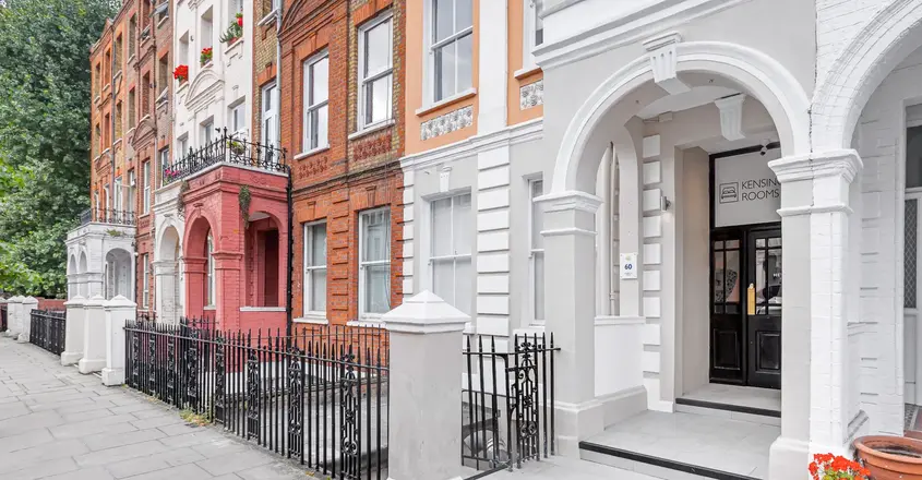 a row of buildings with a fence