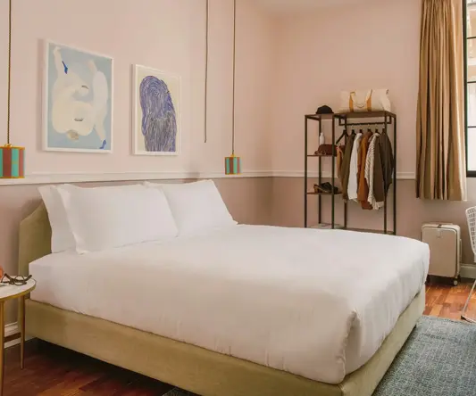 a bedroom with a bed and a shelf