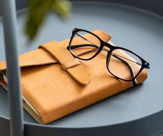 a pair of glasses on a book