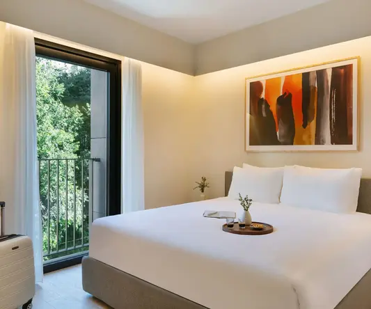 a bed with a tray of flowers on it