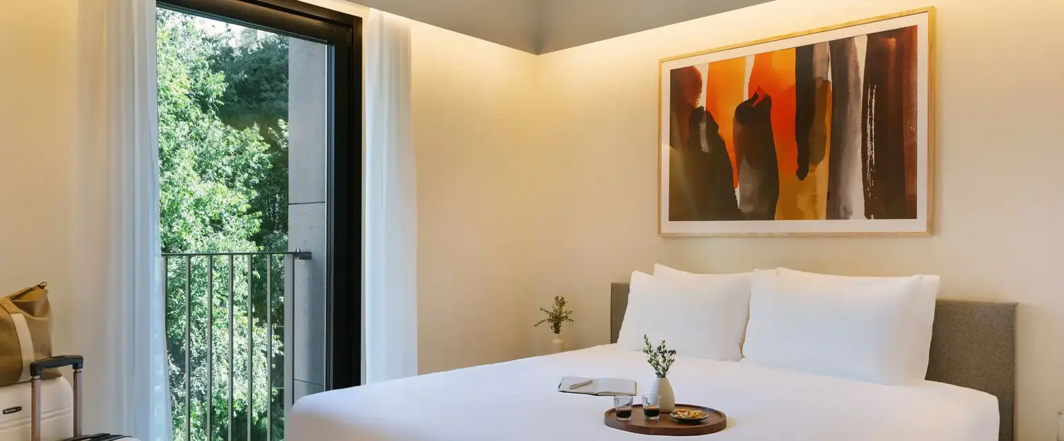 a bed with a tray of flowers on it