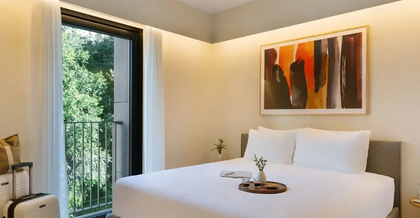 a bed with a tray of flowers on it