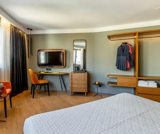 a room with a bed and a tv