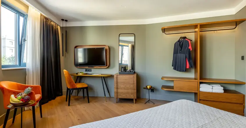 a room with a bed and a tv