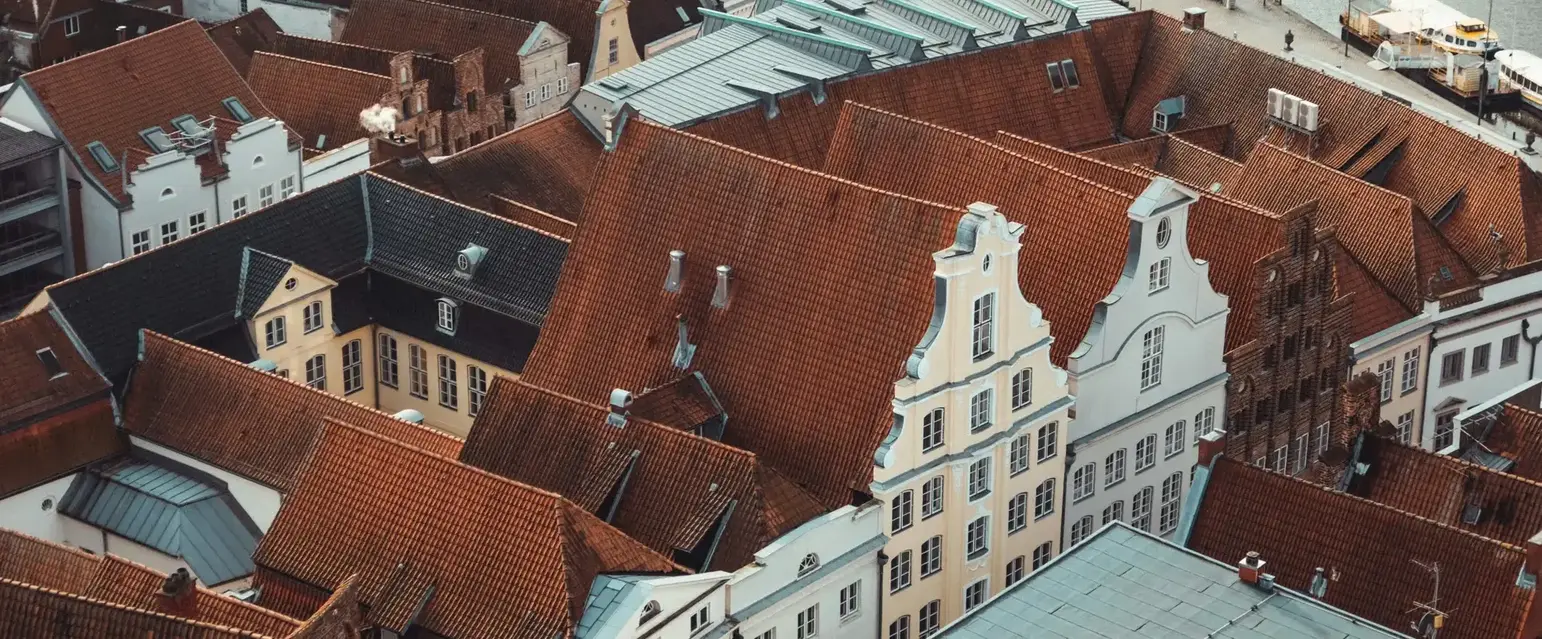 Head up high — those red tiles and pastel facades are Lübeck’s best backdrop.