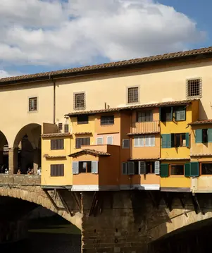 a building with many windows and a bridge over water