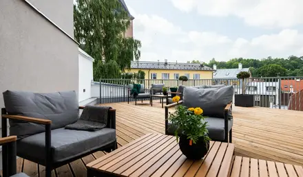 a patio with chairs and a table