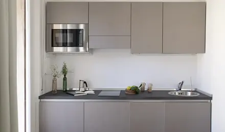 a kitchen with grey cabinets and a microwave