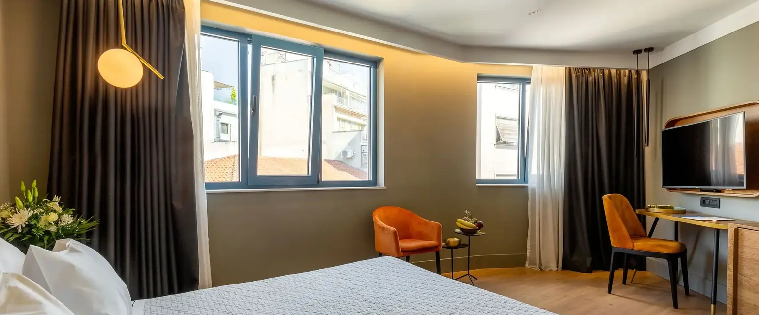 a bedroom with a bed and chairs