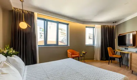 a bedroom with a bed and chairs