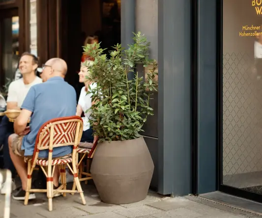 a man and woman sitting outside a restaurant