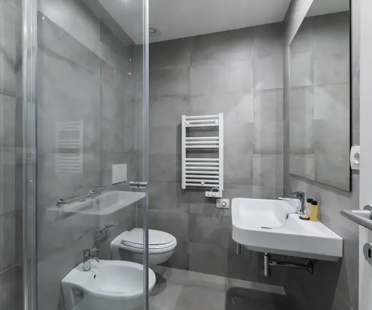 a bathroom with a glass shower door and toilet