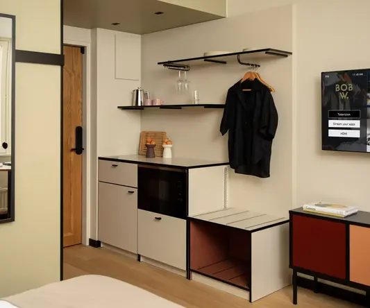 a room with a black coat on a swinger