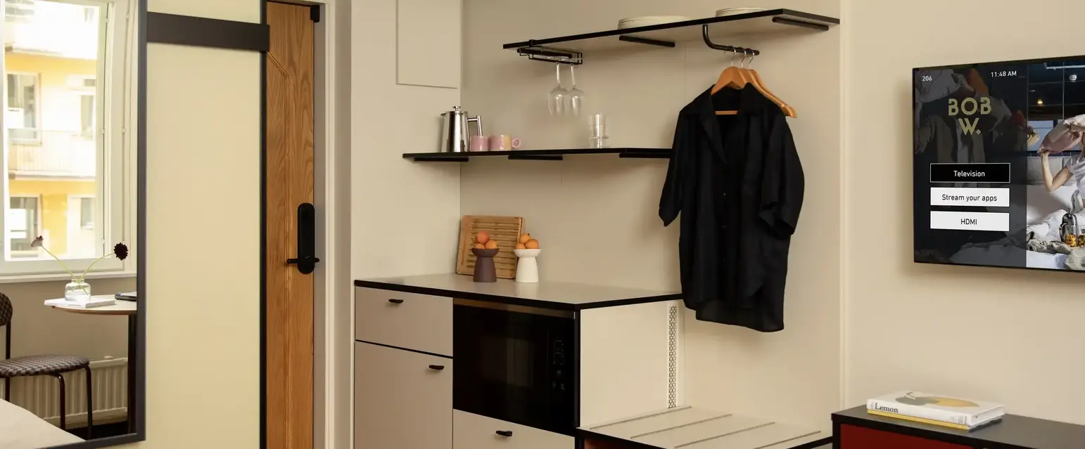 a room with a black coat on a swinger