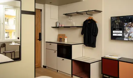 a room with a black coat on a swinger