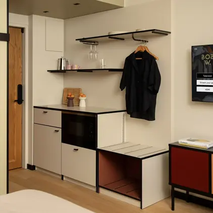 a room with a black coat on a swinger