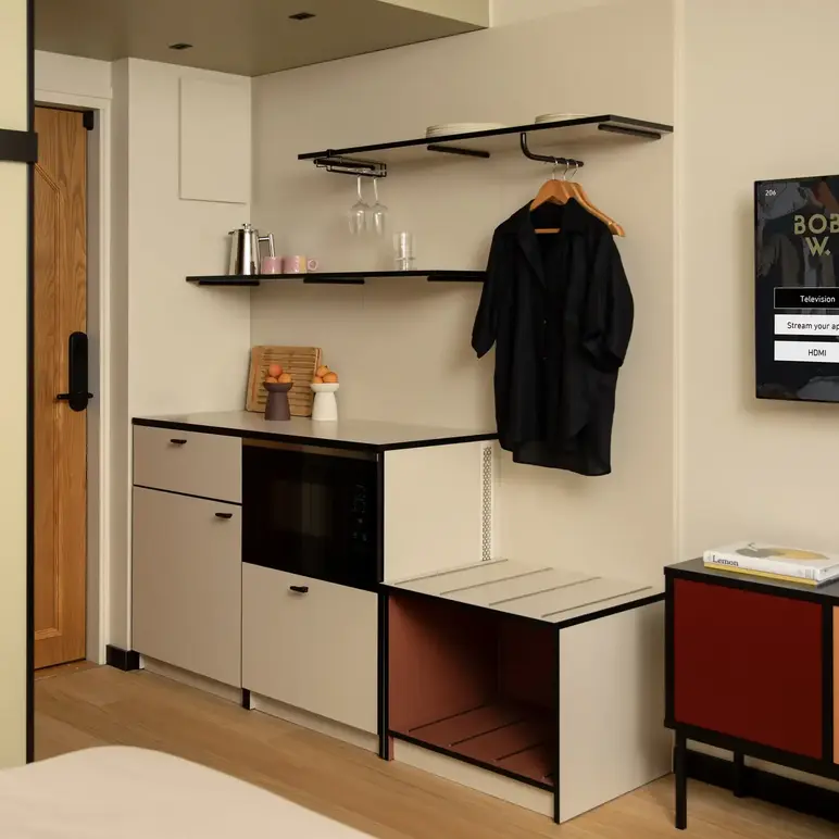 a room with a black coat on a swinger