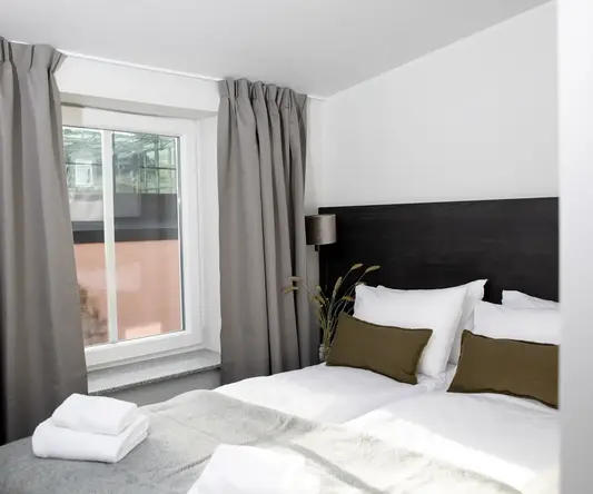 a bed with pillows and towels on it