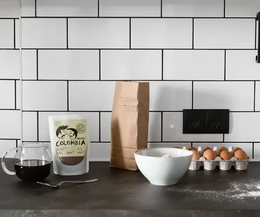 a kitchen counter with a bag of flour and eggs