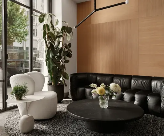 a room with a black couch and a black coffee table