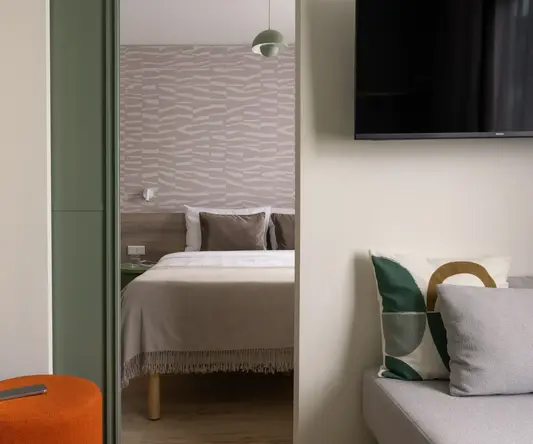 a bedroom with a bed and a tv