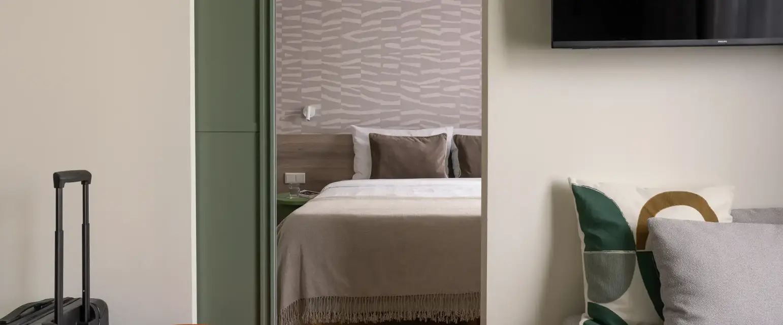 a bedroom with a bed and a tv