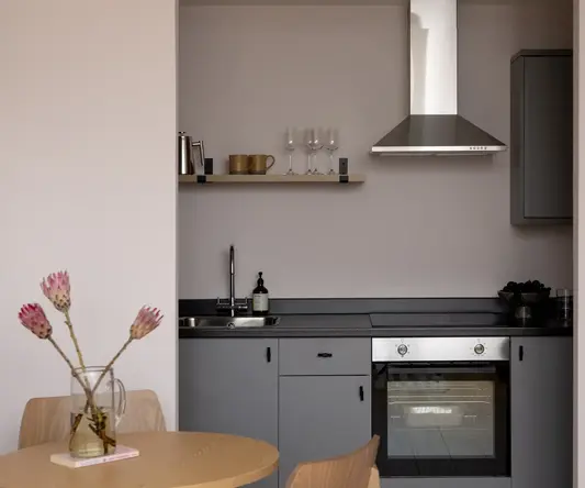 a kitchen with a table and chairs