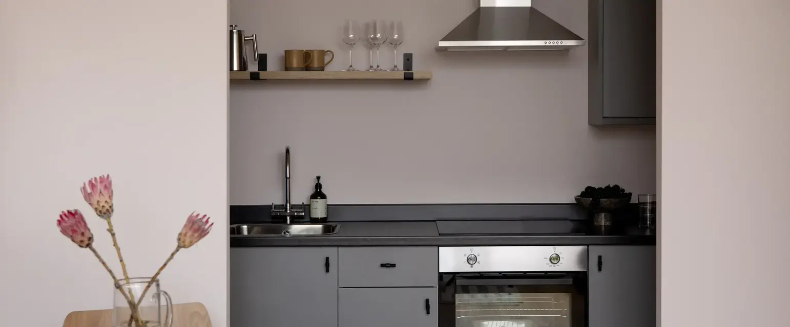 a kitchen with a table and chairs