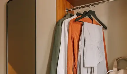 a closet with clothes and a mirror