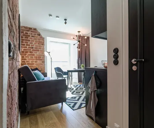 a living room with a couch and a dining table