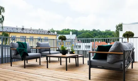 a patio with chairs and a table