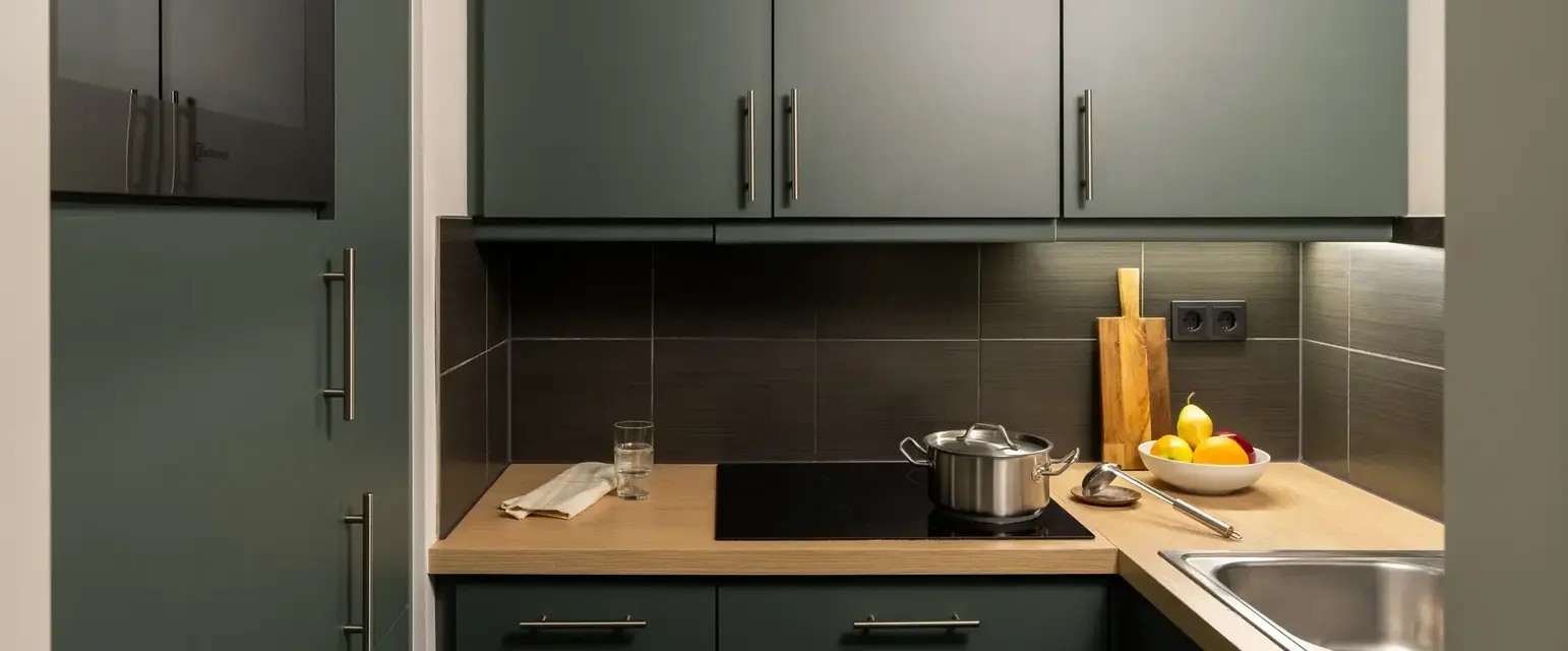 a kitchen with grey cabinets and a stove