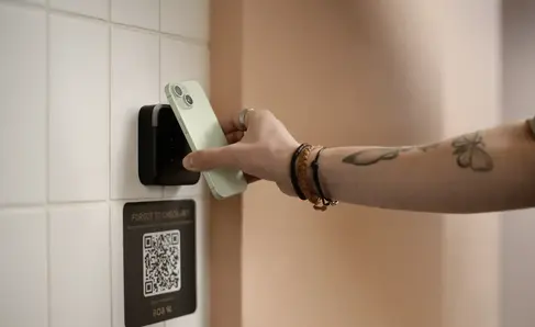 a person using a cell phone to insert a card