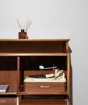 a wooden shelf with a model of a record player