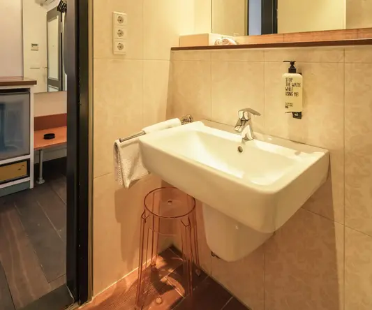 a bathroom with a sink and mirror