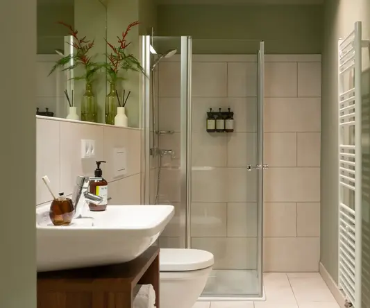 a bathroom with a glass shower door and sink