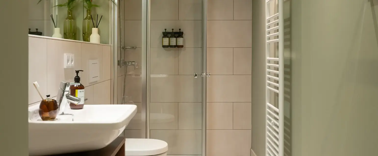 a bathroom with a glass shower door and sink