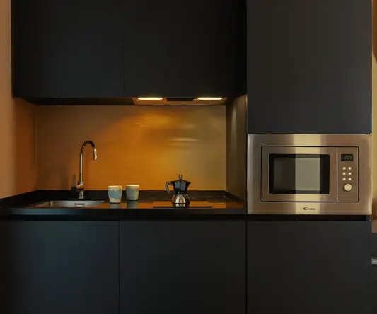 a kitchen with a microwave and a sink