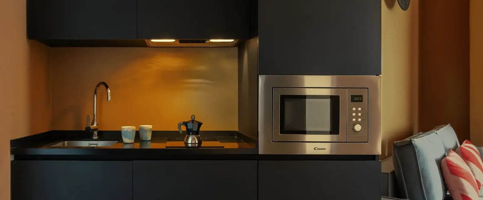 a kitchen with a microwave and a sink