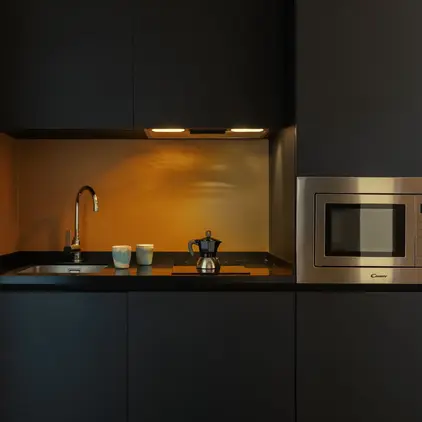 a kitchen with a microwave and a sink