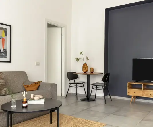 a living room with a table and chairs