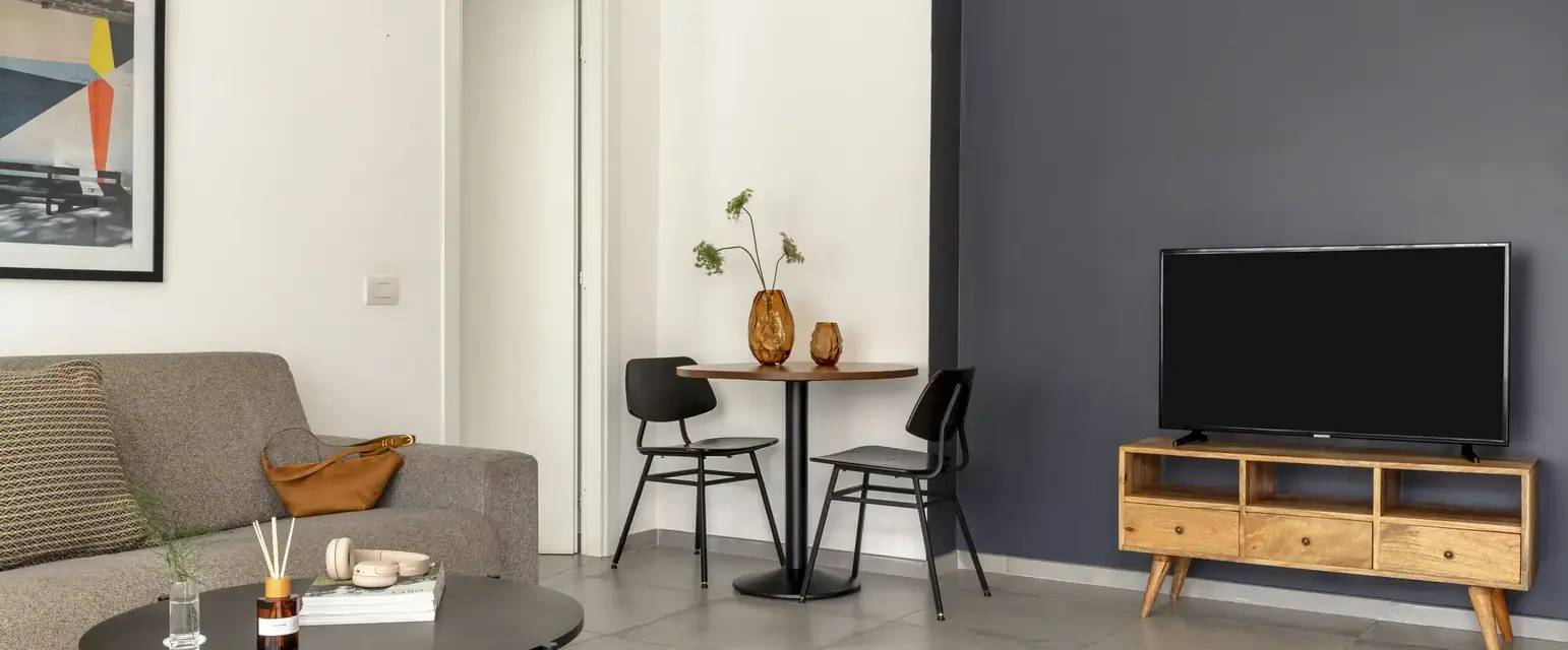 a living room with a table and chairs