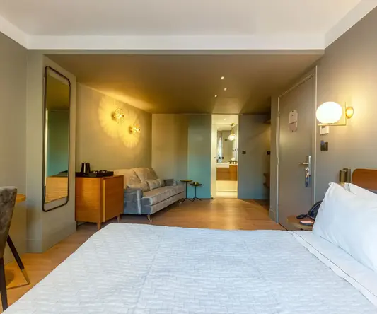 a bedroom with a bed and a couch